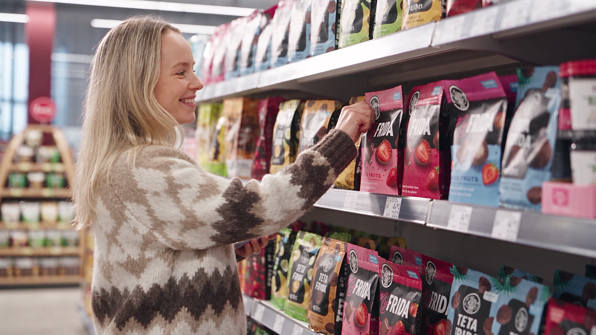 Shopper picking a chocolate fruit pack from a retail shelf